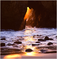 sunset through rock - image